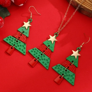 Detailed view of festive Christmas tree necklace and earrings set with gold stars