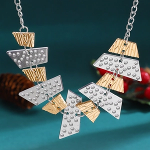 Detailed view of geometric alloy Christmas necklace with gold stripes and silver dots