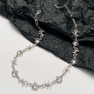 Close-up of edgy silver thorn chain necklace with iridescent opal stones and lobster clasp