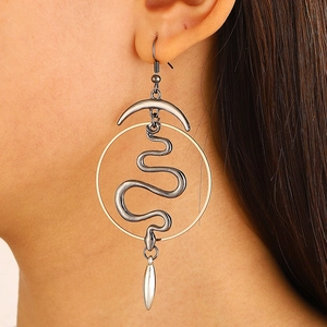 Detail of snake-shaped alloy hoop earring with crescent accents on a female model