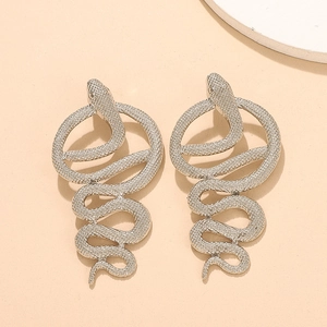 Detailed close-up of oversized silver snake earrings with pavé white rhinestones