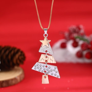 Macro detail of mixed metal Christmas tree pendant with golden star on festive background