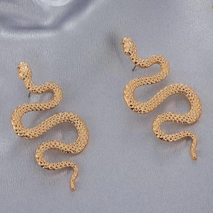 Detailed close-up showing textured scales on gold-colored punk snake stud earrings