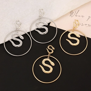 Detailed view of punk snake drop earrings with scale texture in gold and silver finish