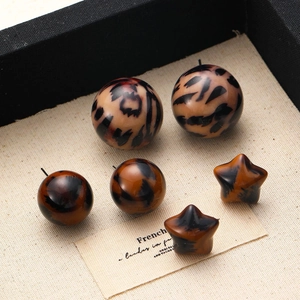 Vintage leopard print acrylic jewelry pieces in sphere and star shapes with glossy finish