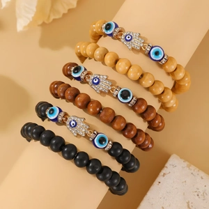 Three-piece elastic beaded bracelet set with Hamsa Hand charm and blue Evil Eye details