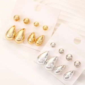 Dettaglio del set di orecchini geometrici a sfera e goccia in oro e argento