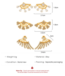 Detailed views of gold fan-shaped earrings with zircons and teardrop crystal pendants