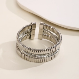 Macro shot of triple-layer silver metal cuff showing fine screw-thread texture details