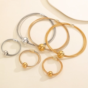 Close-up of multilayer metal wire necklaces with magnetic clasps and polished spheres