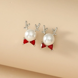 Elegant Christmas reindeer pearl earrings with silver antlers and red zircon bows on beige
