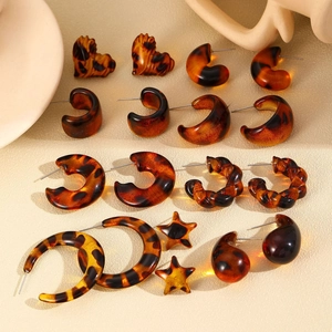 Macro detail of various vintage leopard print acrylic and resin earrings set