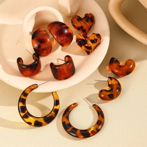 Detailed macro view of vintage leopard print resin earring set in various geometric shapes