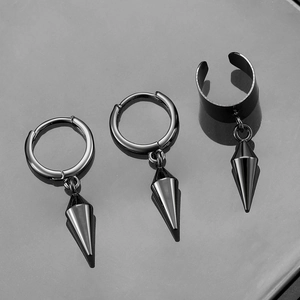 Macro shot of gunmetal black punk spike earring set with reflective surface detail