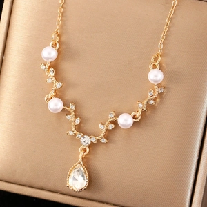 Elegant gold antler necklace with pearls, zircon accents and teardrop pendant