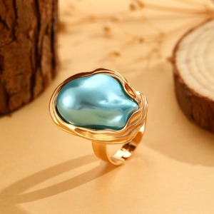 Makro-Detail der hellblauen Barockperle auf einem gewellten goldenen Ring