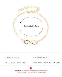 Detailed view of golden infinity symbol chain bracelet with adjustable link clasp