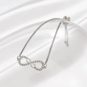 Detail view of silver infinity bracelet with white cubic zirconia and adjustable box chain