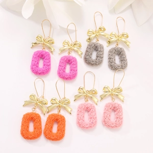 Detail showing four colors of rose floral earrings with elegant gold bow accents