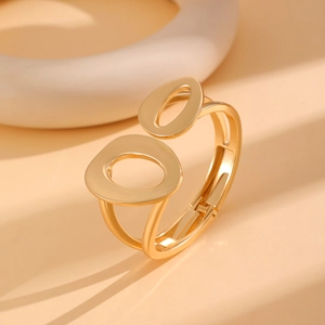 Detailed macro view of the gold hollow oval hinge opening on the punk style metal bracelet