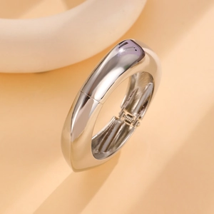 Macro shot of polished silver wide band spring cuff bracelet with hinge detail