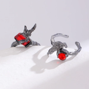 Macro detail of gothic eagle claw ring with ruby red gemstone and vintage black finish