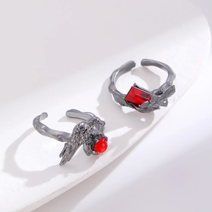 Macro detail of dark punk open ring with dragon claw design and square red gemstone