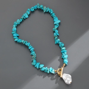 Turquoise gravel necklace featuring a large baroque pearl pendant and gold T-bar clasp