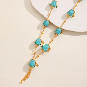 Bohemian turquoise bead long necklace with gold hollowed charms and tassel accents