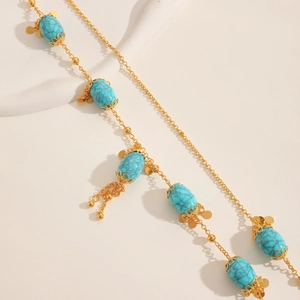 Detailed macro shot of vintage turquoise beads with intricate gold filigree caps