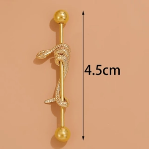 Macro detail of a 4.5cm golden industrial barbell featuring an intricate snake design