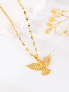 Macro shot of gold-plated eagle pendant necklace with pink and white cubic zirconia