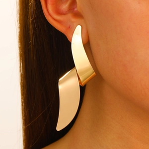 Chic oversized gold liquid lava geometric earrings worn by model for a modern metal look