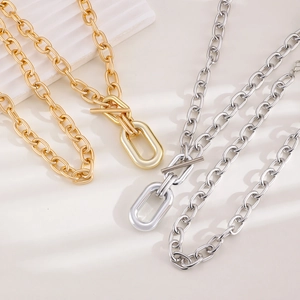Detail of chunky metal link chain necklace featuring a classic T-bar OT toggle closure