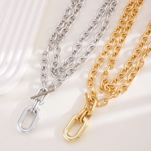 Industrial style gold and silver thick link necklaces with OT toggles on a white tray