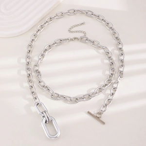 Detailed view of silver metal chunky chain necklace and bracelet with OT toggle clasp
