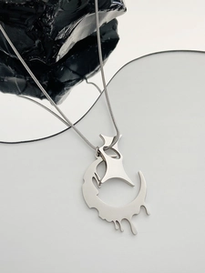 Detailed view of gothic silver lava heart pendant on a chain with mirror reflection