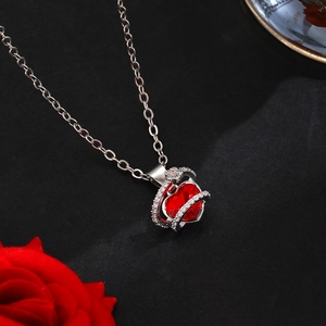 Close-up of a red heart crystal pendant necklace with sparkling zircon and silver chain