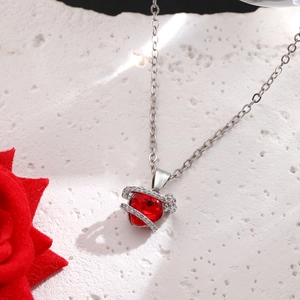 Elegant planet heart necklace with red crystal pendant and silver diamond ribbon detail