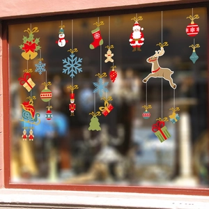 Macro detail of festive Christmas window clings featuring Santa, reindeer and snowflakes