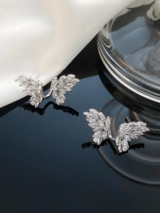 Close-up of butterfly stud earrings with sparkling marquise and round cut zircons