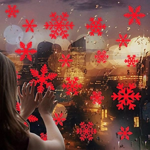 Red Christmas snowflake window decals applied to glass window with festive city lights background