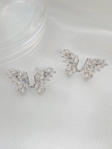 Macro view of silver butterfly wing studs with marquise-cut marquise white zircon stones