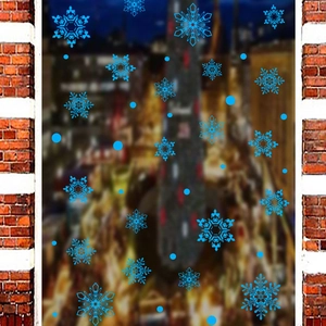 Adesivi blu a forma di fiocchi di neve e punti su vetro con sfondo urbano invernale