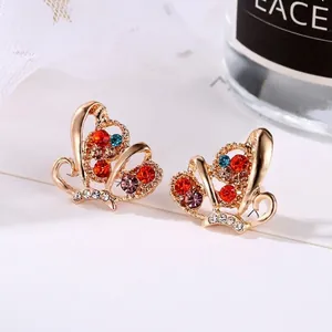 Macro shot of heart-shaped rhinestone earrings with detailed gold hollow design