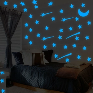 Luminous wall stickers featuring blue glow stars and a crescent moon in a dark bedroom