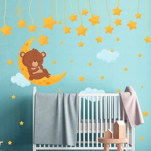 Detail of sleeping bear on moon wall sticker with stars and clouds for nursery decor
