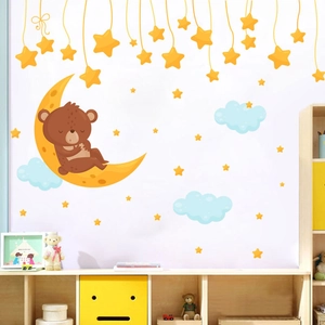 Cute brown bear sleeping on crescent moon wall sticker with stars and clouds for nursery
