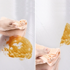 Macro shot of waterproof EVA cabinet liner with square grid texture and cleaning cloth