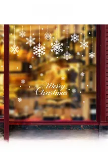 Detail of white snowflake window stickers and Merry Christmas lettering on glass surface